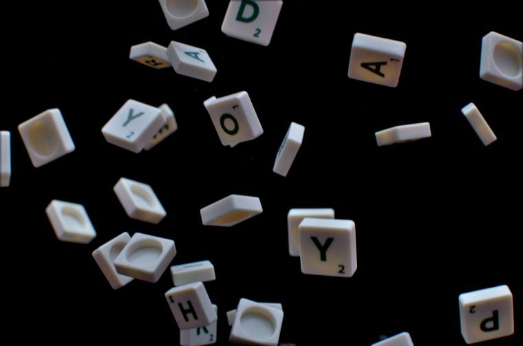 Photography of scrabble pieces raining from above