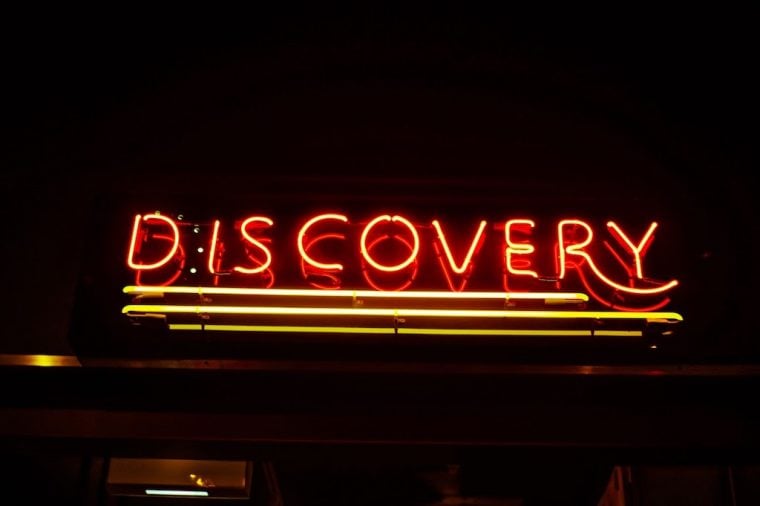 Photograph of a neon sign that reads Discovery
